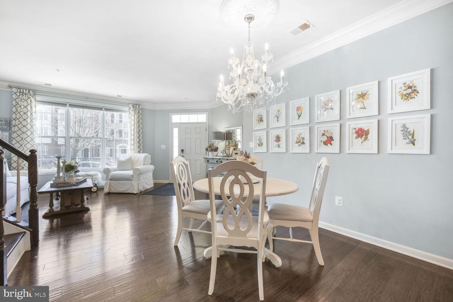 43037 Clarks Mill Terrace Ashburn, VA 20148 - Photo 8 of 28 a view of a dining room with furniture wooden floor and chandelier