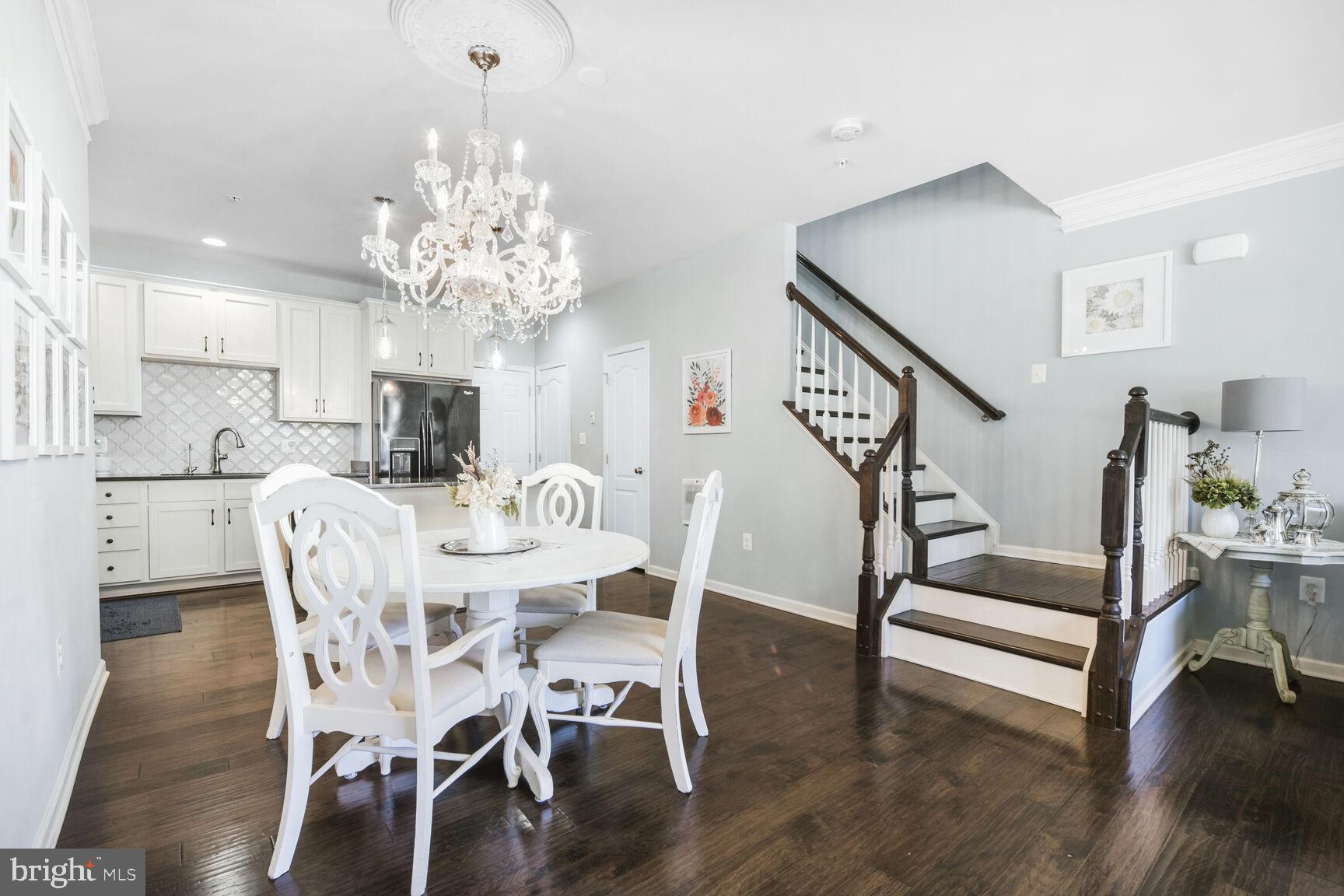 43037 Clarks Mill Terrace Ashburn, VA 20148 - Photo 9 of 28 a view of a dining room with furniture wooden floor and chandelier