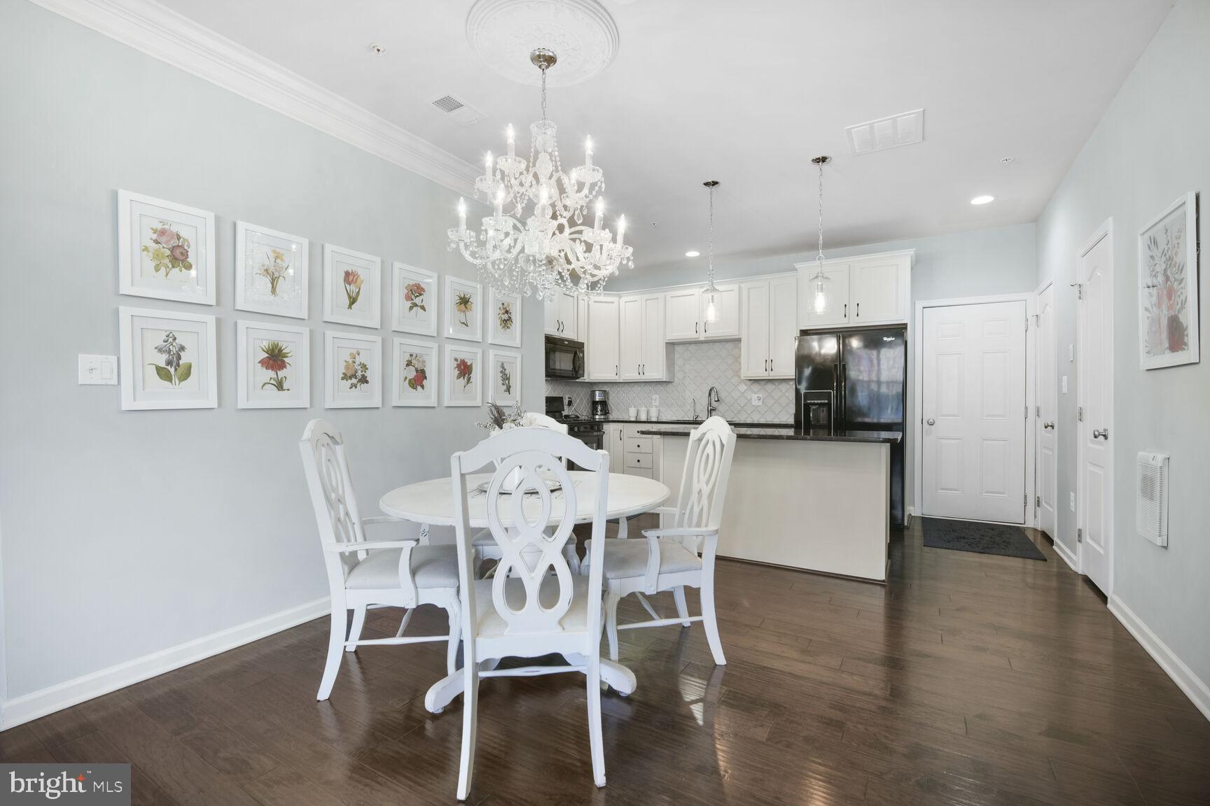 43037 Clarks Mill Terrace Ashburn, VA 20148 - Photo 10 of 28 a view of a dining room with furniture and chandelier
