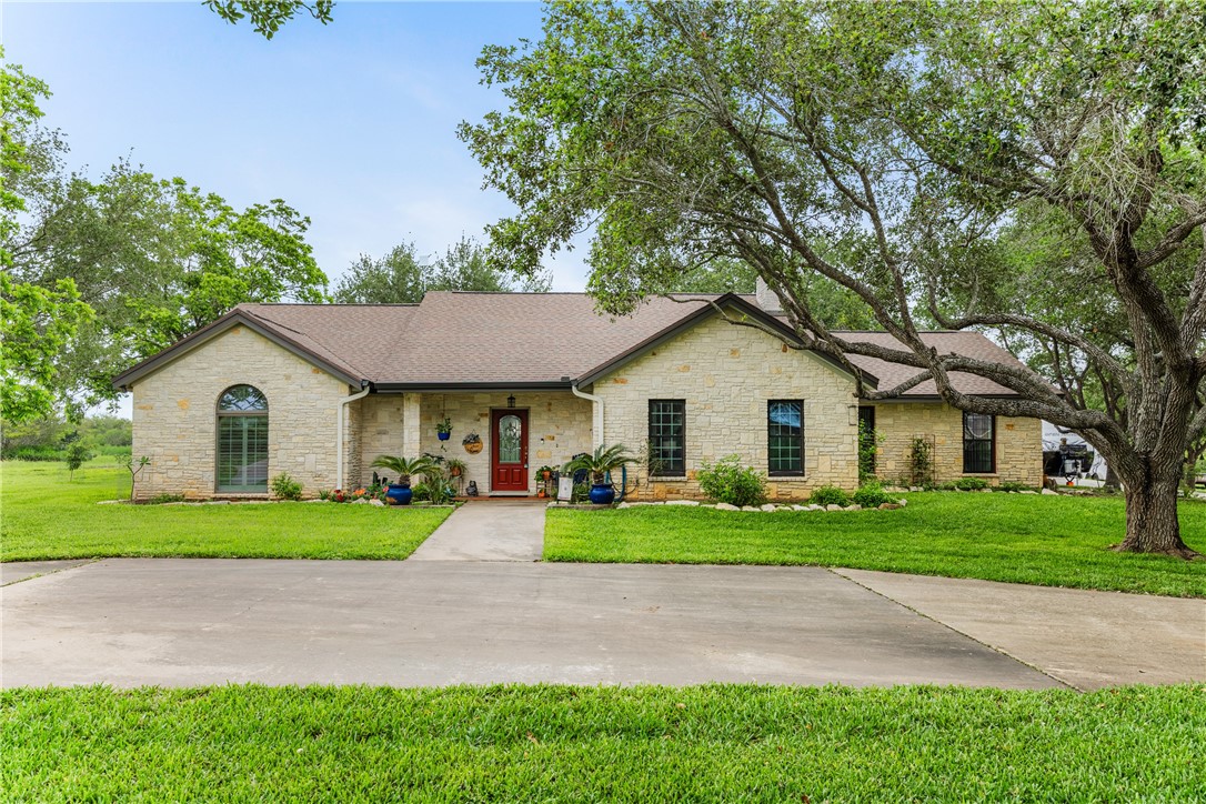345 Trail Ridge Drive Sandia, TX 78383 - Photo 3 of 40 a view of a yard in front of a house with large trees