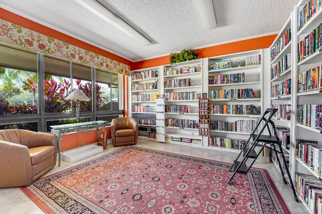 a view of a tennis ground with large trees