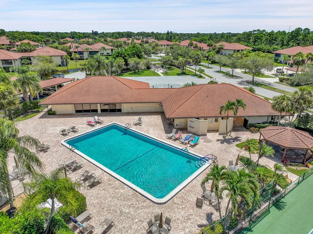 an aerial view of residential houses with outdoor space and parking