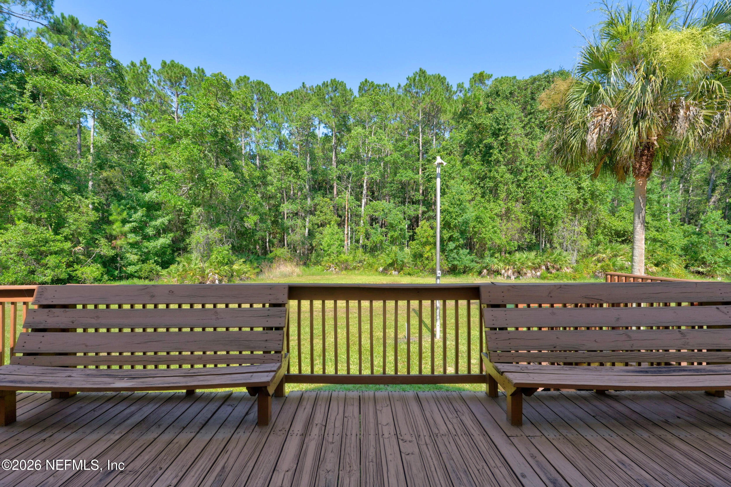 3090 Monument Bay Road St. Augustine, FL 32092 - Photo 41 of 56 a view of a wooden deck with a bench