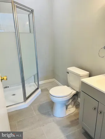 a white toilet sitting next to a sink
