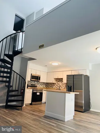 a view of kitchen with cabinets and wooden floor