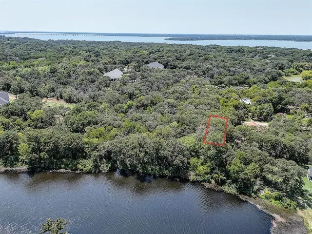 an aerial view of a houses with ocean view
