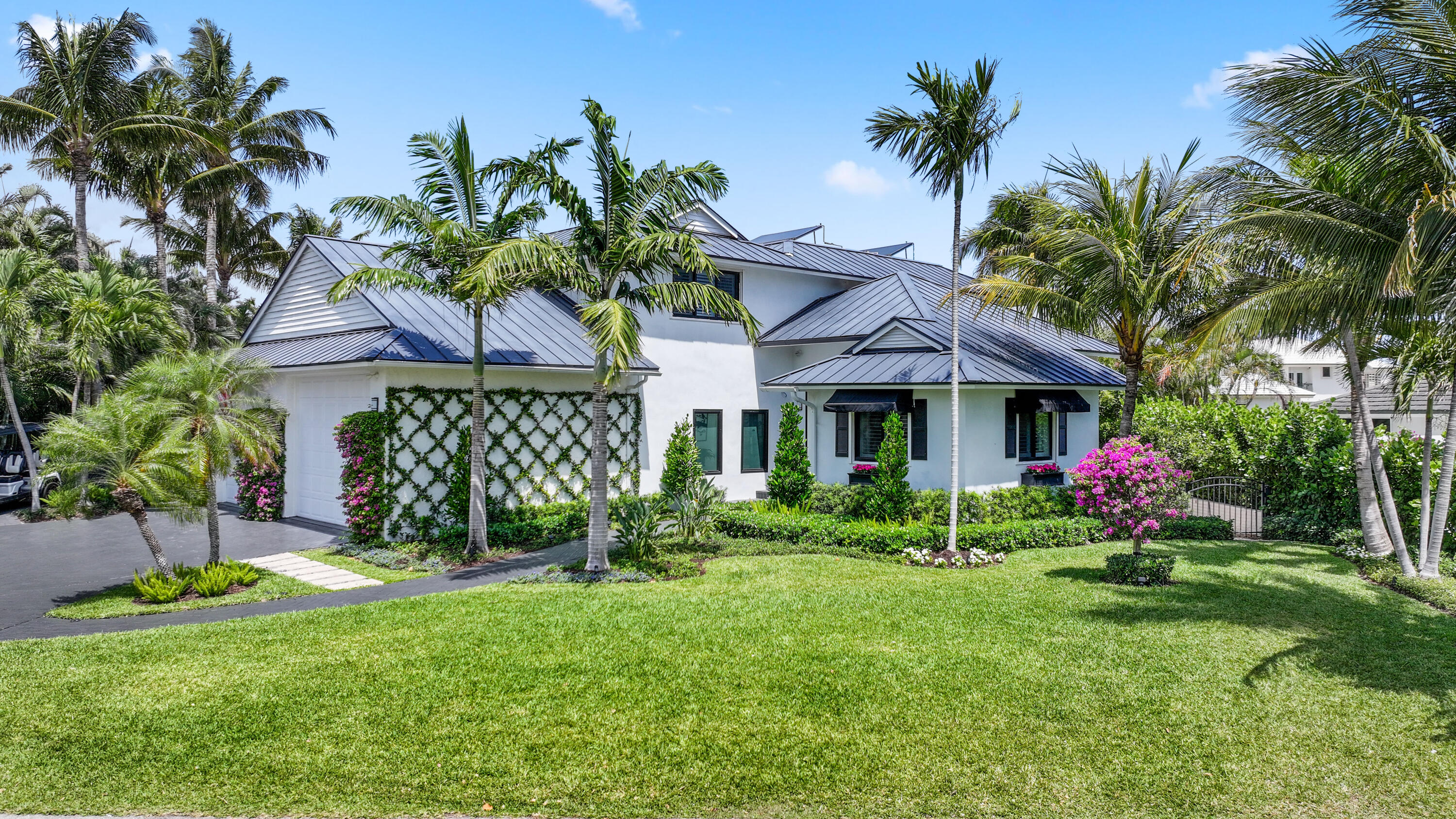 125 Marlin Drive Ocean Ridge, FL 33435 - Photo 103 of 122 a view of a house with a yard and potted plants
