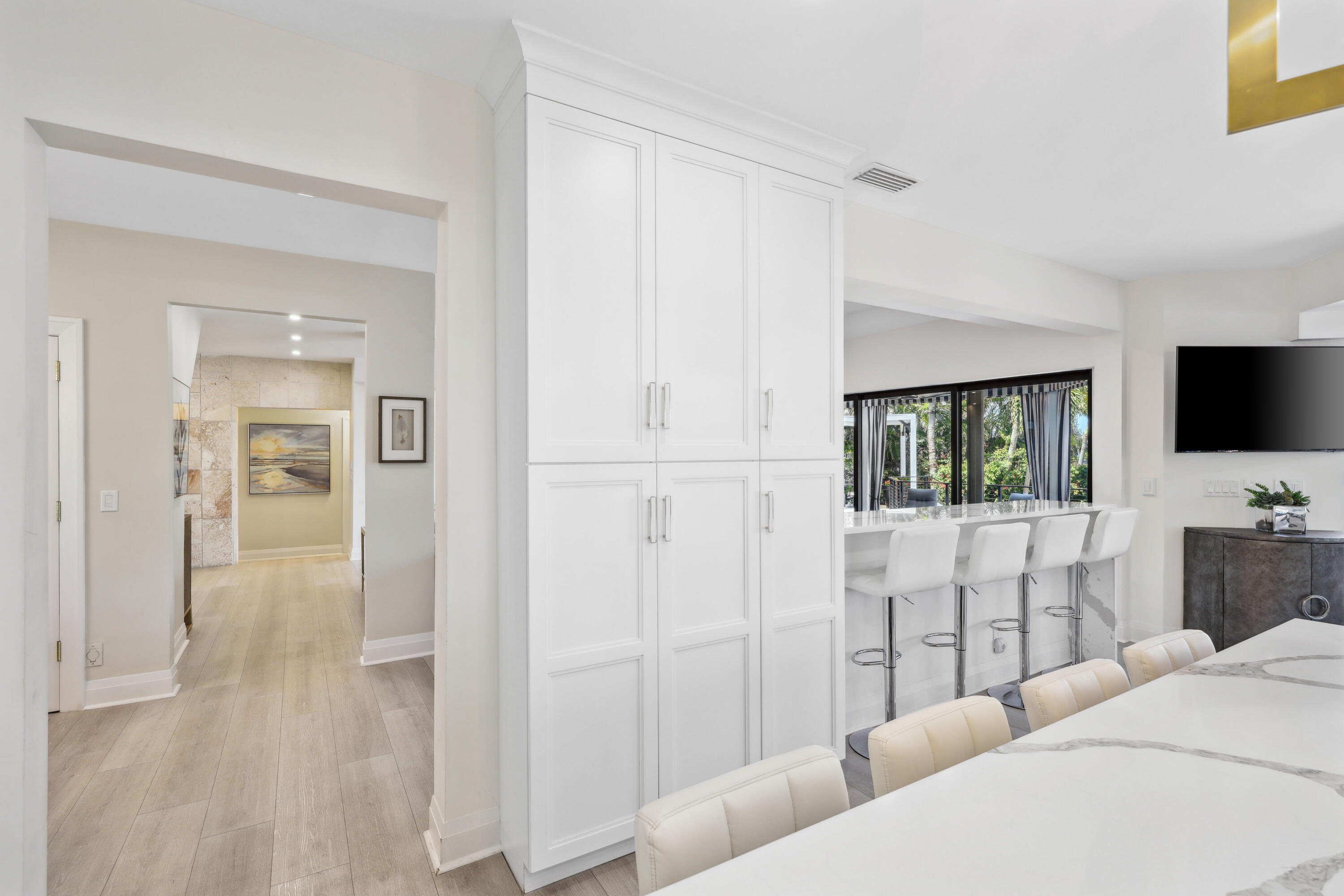 125 Marlin Drive Ocean Ridge, FL 33435 - Photo 17 of 122 a living room with furniture a flat screen tv and a refrigerator