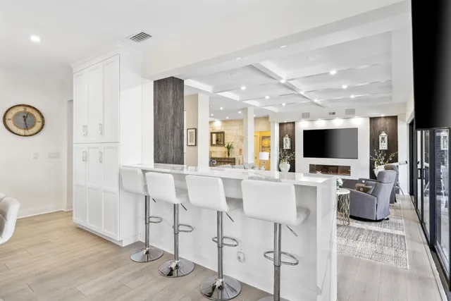 a view of a balcony with wooden floor and potted plants