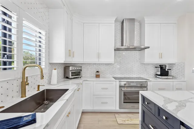 a bedroom with a bed and a flat tv screen on dresser