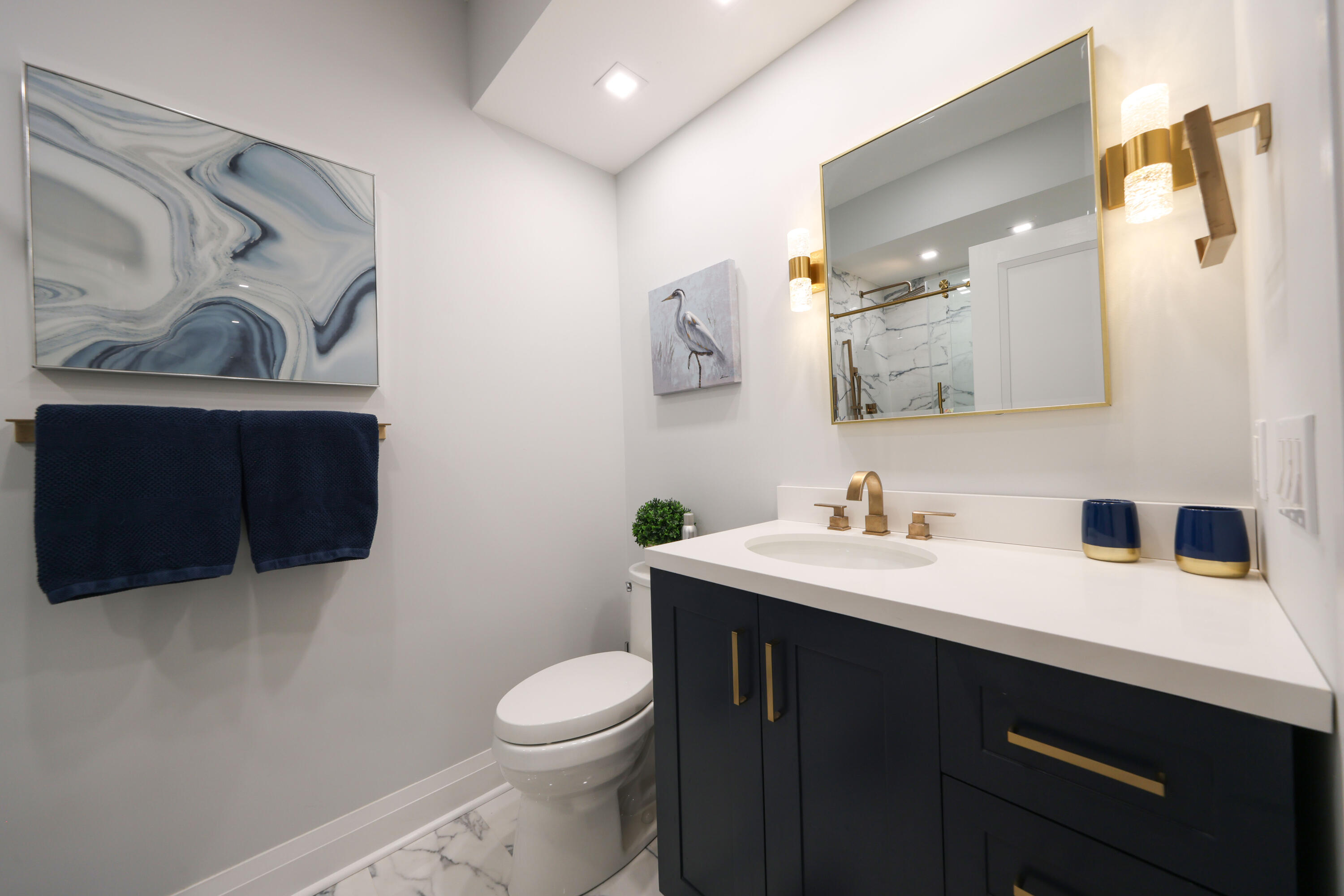 125 Marlin Drive Ocean Ridge, FL 33435 - Photo 57 of 122 a bathroom with a toilet a sink and mirror