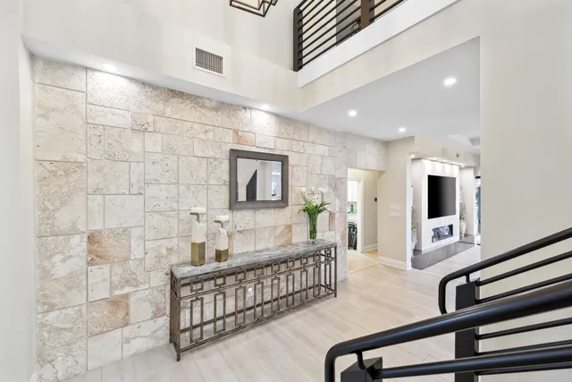 a kitchen with stainless steel appliances granite countertop a sink a stove and a refrigerator