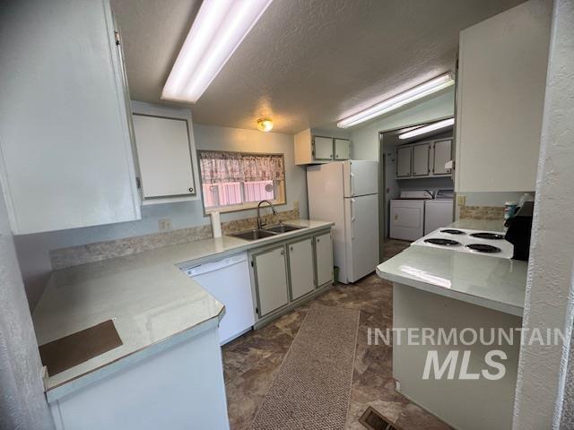 910 Moonglo, Unit 49 Buhl, ID 83316 - Photo 9 of 16 Kitchen with light countertops, washer and dryer, white appliances, and white cabinets