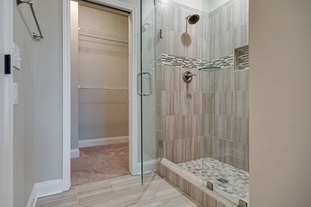 a bathroom with a glass shower door