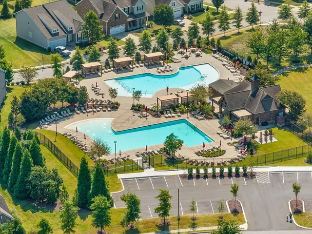 an aerial view of a house with a swimming pool