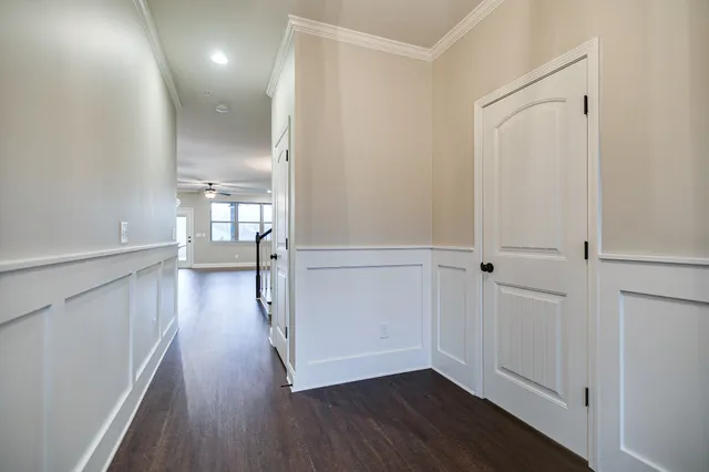 a view of a hallway with wooden floor