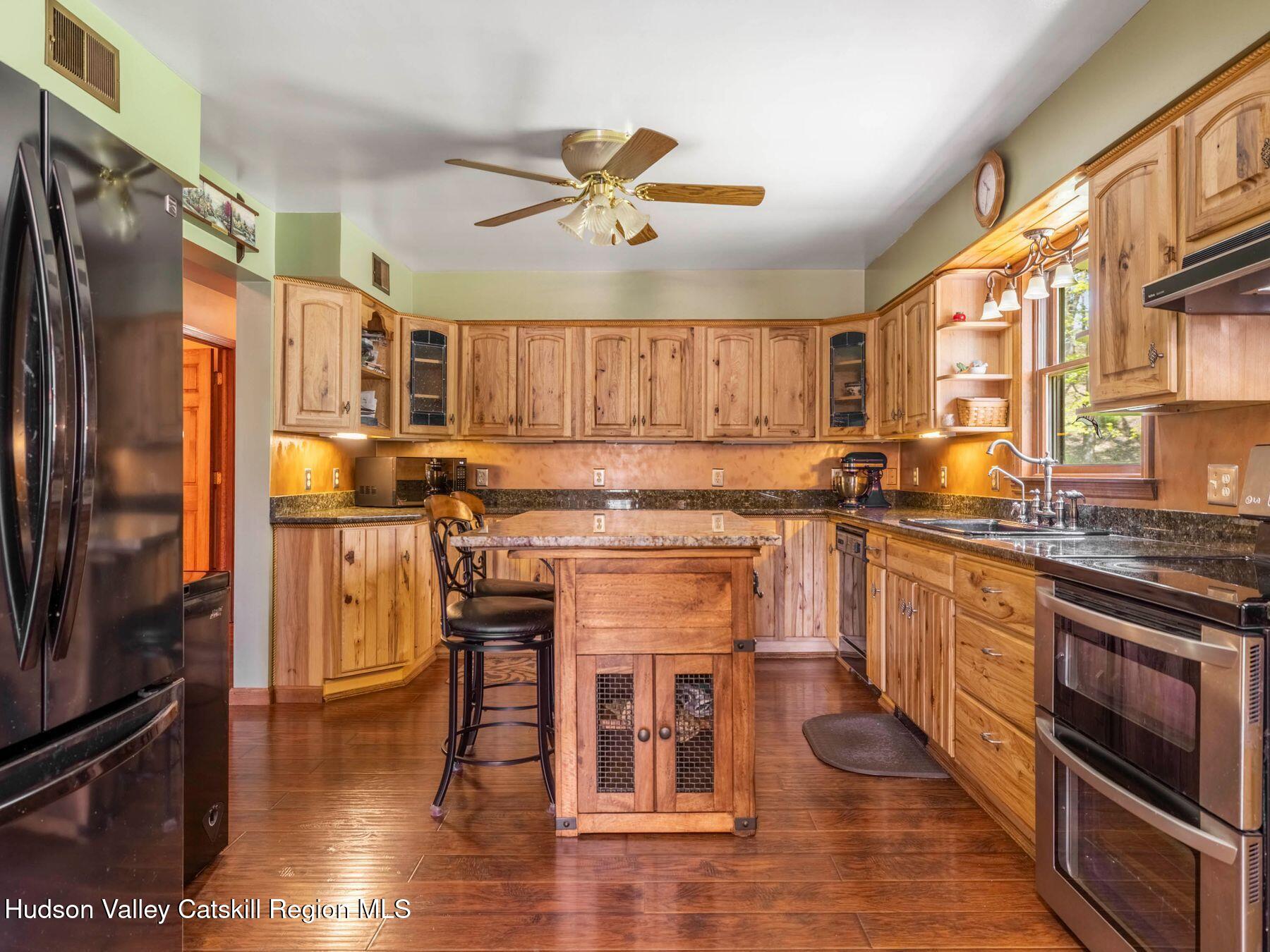 3639 Atwood Road Stone Ridge, NY 12484 - Photo 13 of 31 a kitchen with stainless steel appliances granite countertop a refrigerator a stove and a sink