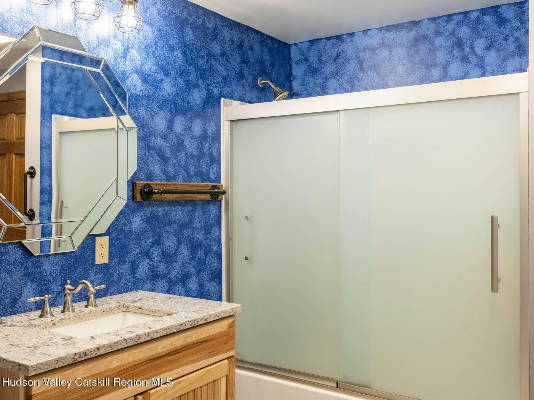 3639 Atwood Road Stone Ridge, NY 12484 - Photo 23 of 31 a bathroom with a granite countertop sink and a mirror