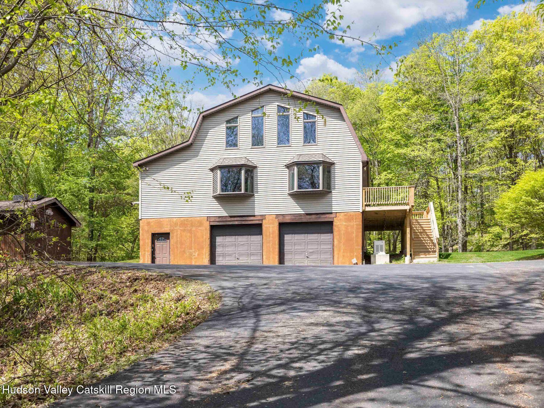 3639 Atwood Road Stone Ridge, NY 12484 - Photo 28 of 31 a front view of a house with large trees