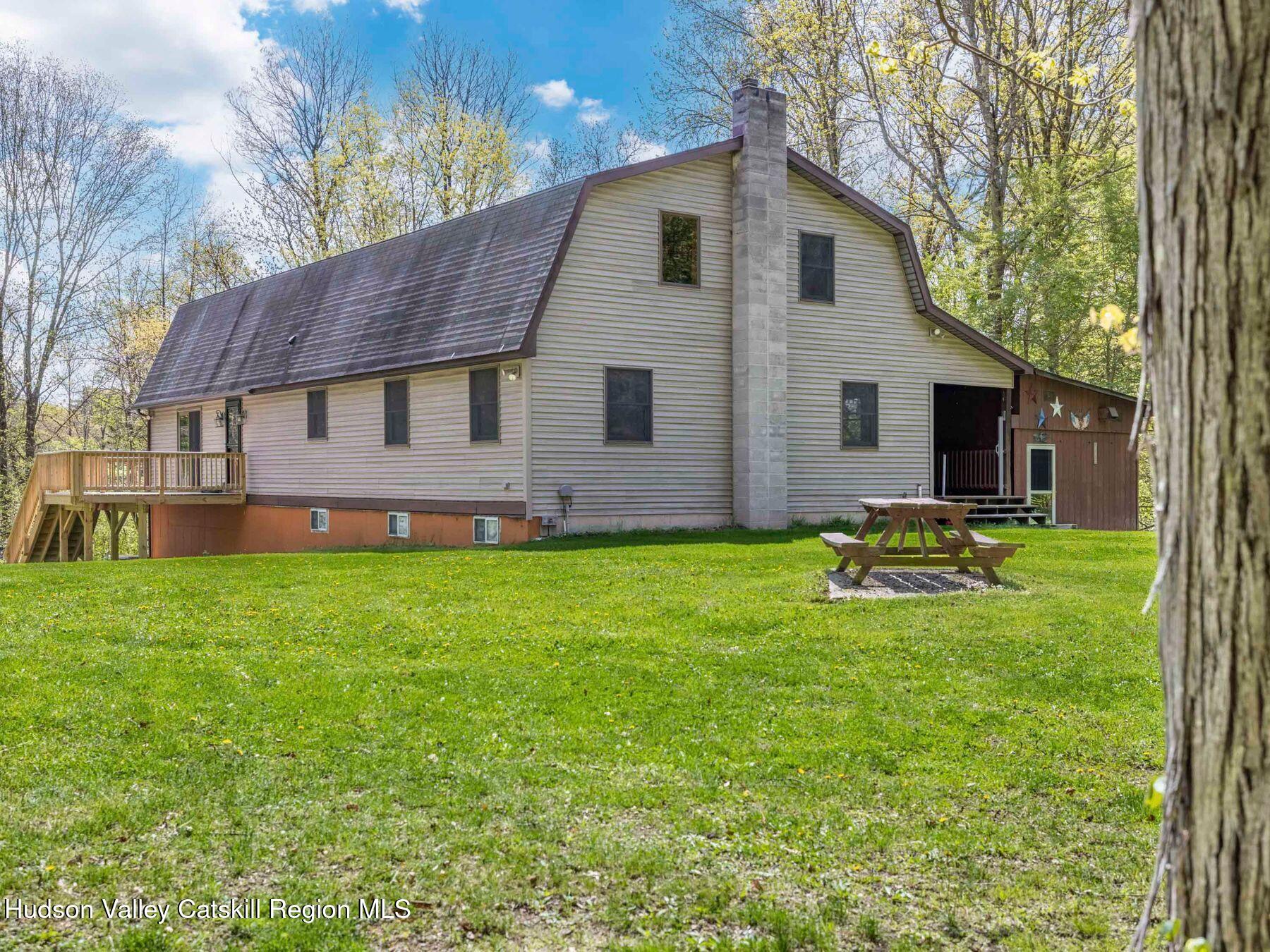 3639 Atwood Road Stone Ridge, NY 12484 - Photo 29 of 31 a view of a house with a yard and sitting area