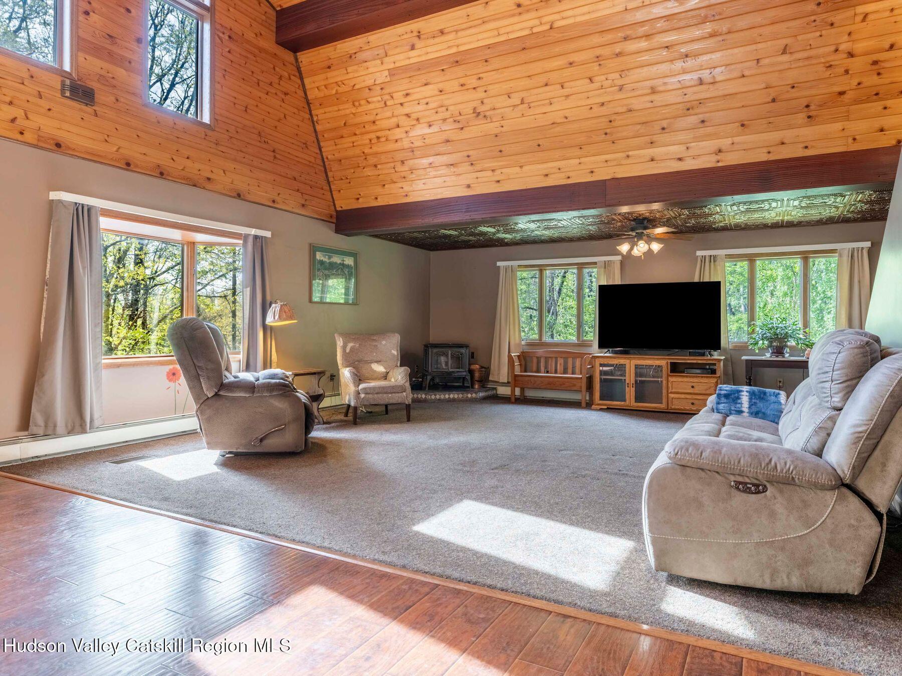 3639 Atwood Road Stone Ridge, NY 12484 - Photo 7 of 31 a living room with furniture and a flat screen tv