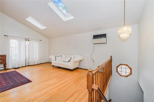 a view of a livingroom with furniture wooden floor and window