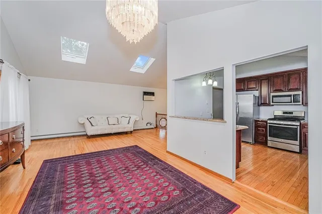 a large white kitchen with a stove a microwave and a refrigerator
