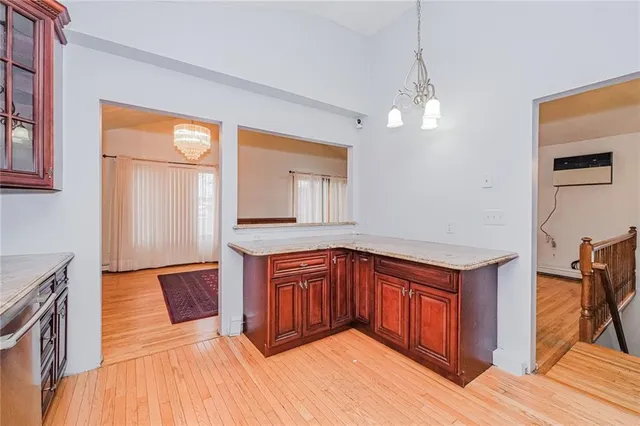 a kitchen with stainless steel appliances granite countertop a sink and wooden cabinets