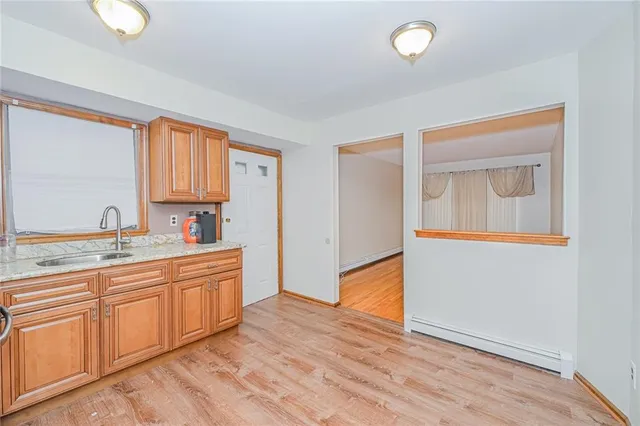 a view of a kitchen with wooden floor and a sink