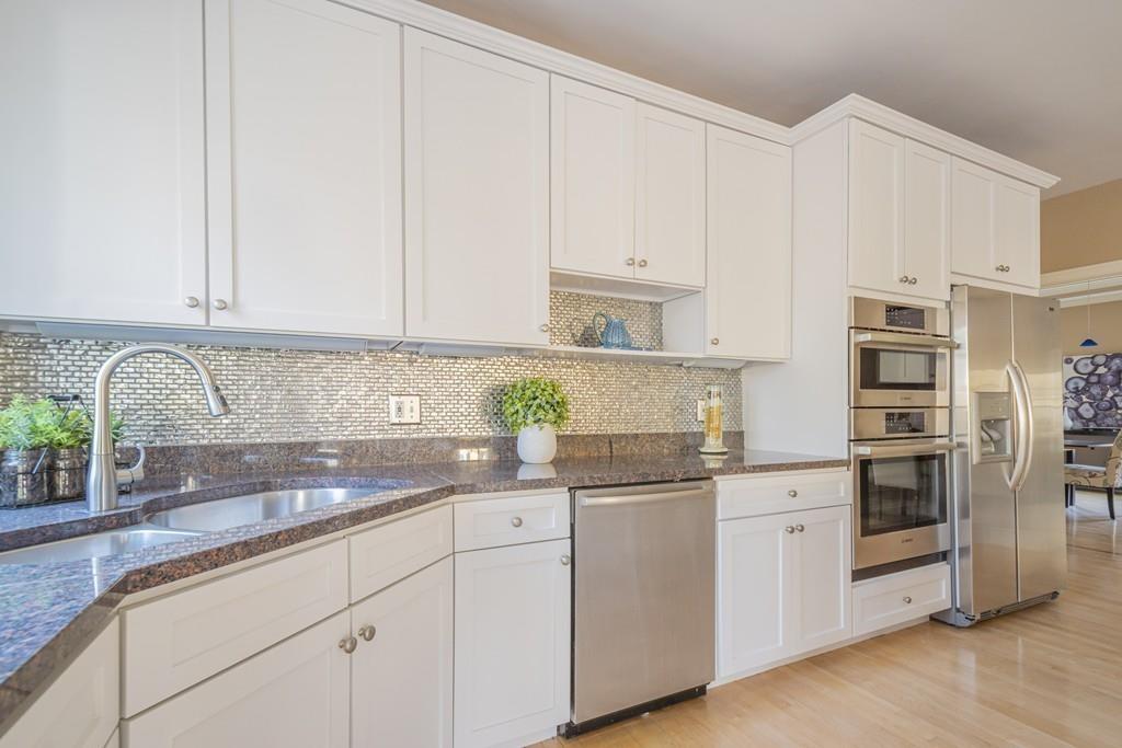 6 Johnson Farm Road Lexington, MA 02420 - Photo 13 of 42 a kitchen with granite countertop white cabinets and white appliances
