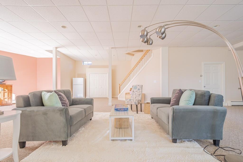6 Johnson Farm Road Lexington, MA 02420 - Photo 37 of 42 a living room with furniture and a chandelier