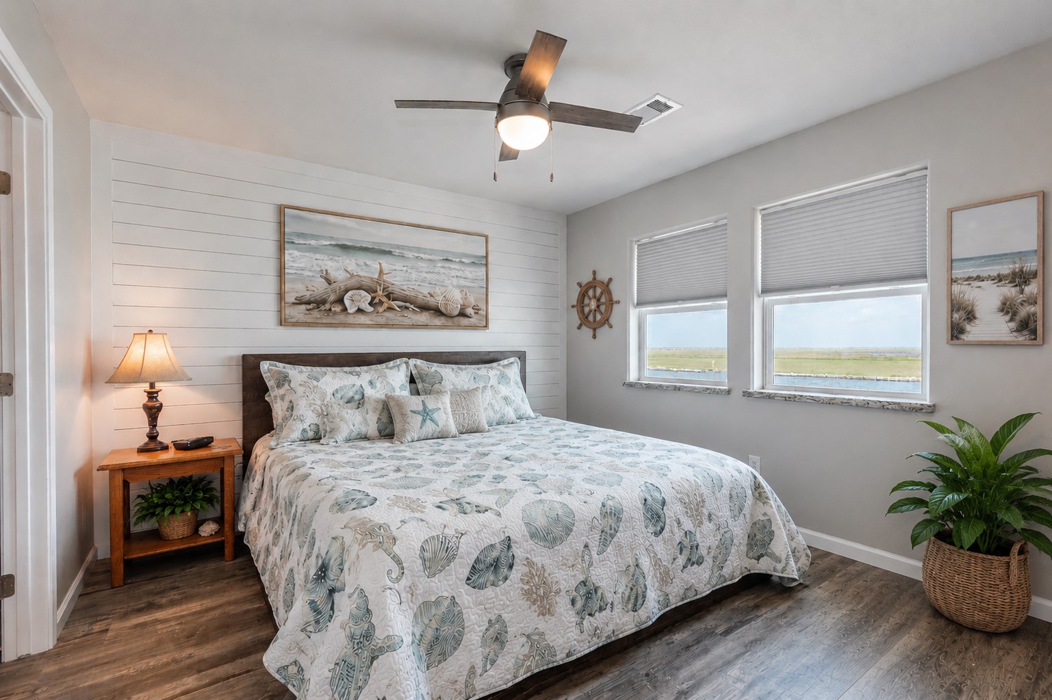 1453 County Road 230 Sargent, TX 77414 - Photo 14 of 38 Primary Bedroom — Enjoy beautiful views of the Intracoastal Waterway right from the bedroom window. Virtually staged décor to showcase a tranquil coastal-inspired retreat