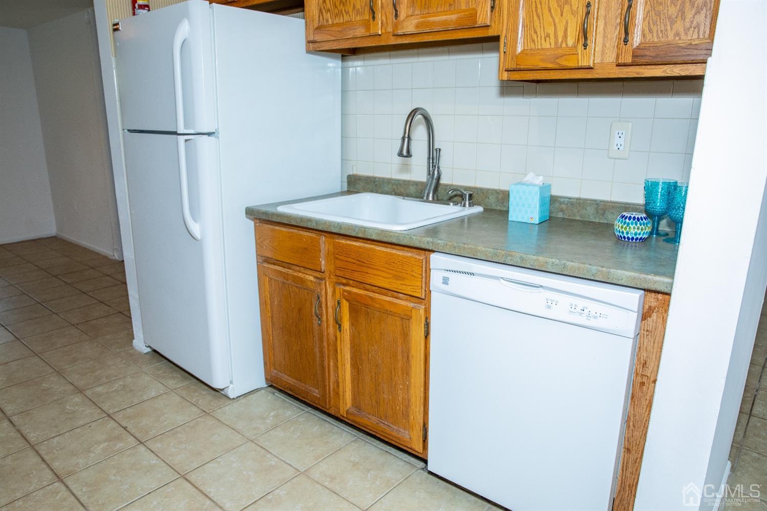 111 Keystone Court, Unit A Woodbridge, NJ 07095 - Photo 15 of 33 a kitchen with stainless steel appliances granite countertop a refrigerator and a sink