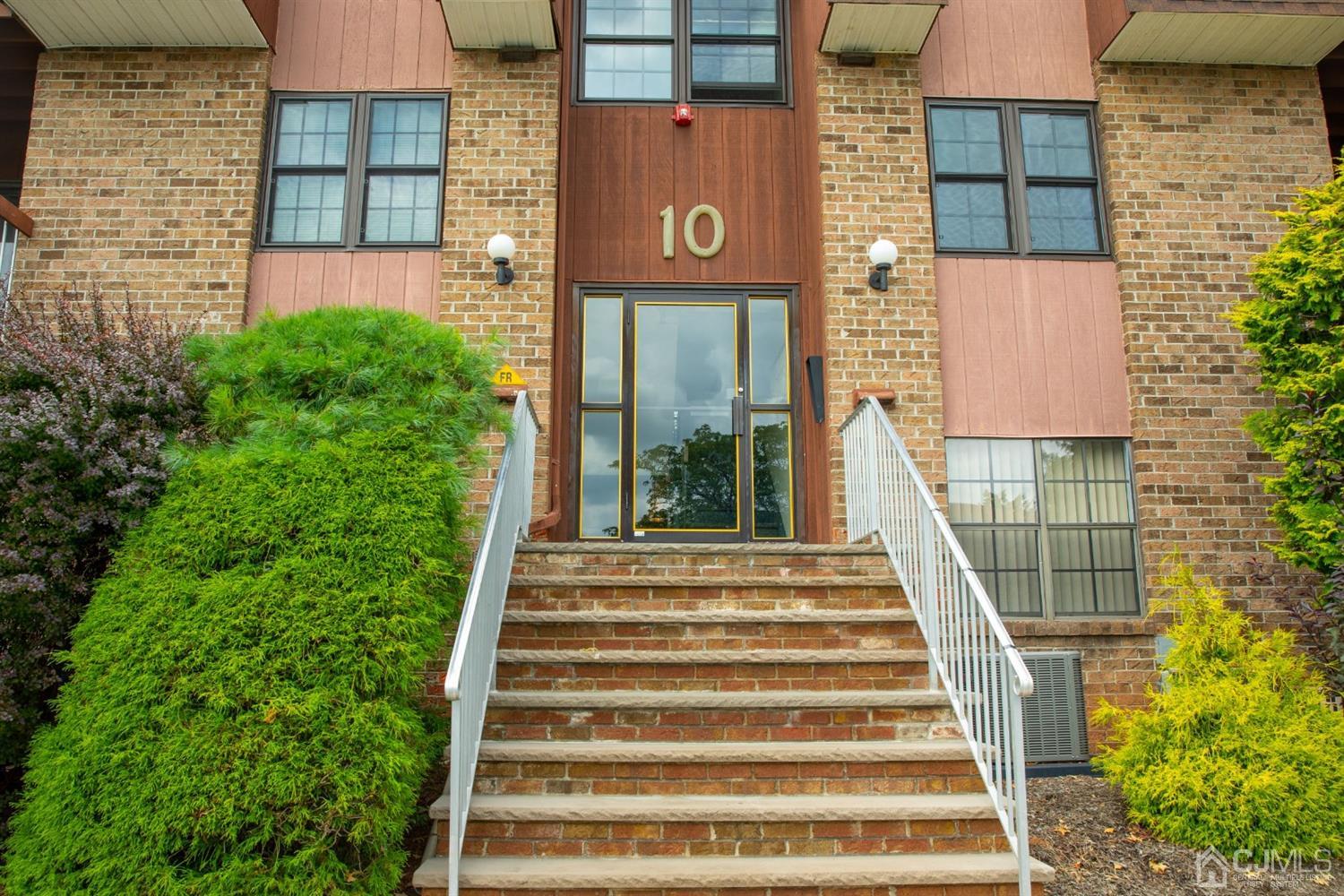 111 Keystone Court, Unit A Woodbridge, NJ 07095 - Photo 3 of 33 a front view of a house with a garden