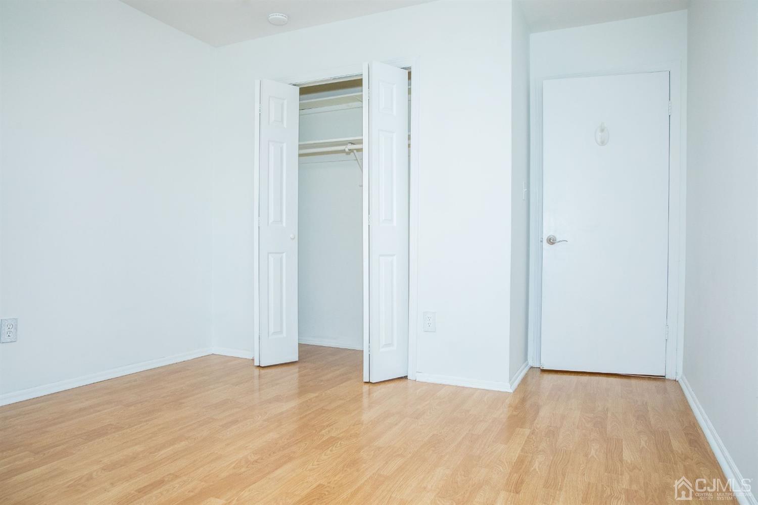 111 Keystone Court, Unit A Woodbridge, NJ 07095 - Photo 32 of 33 a view of empty room with wooden floor