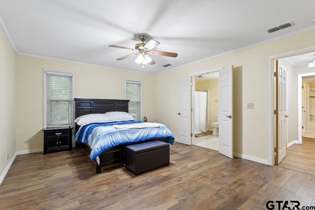 448 North Hill Road Tyler, TX 75706 - Photo 17 of 30 a spacious bedroom with a bed and a chandelier
