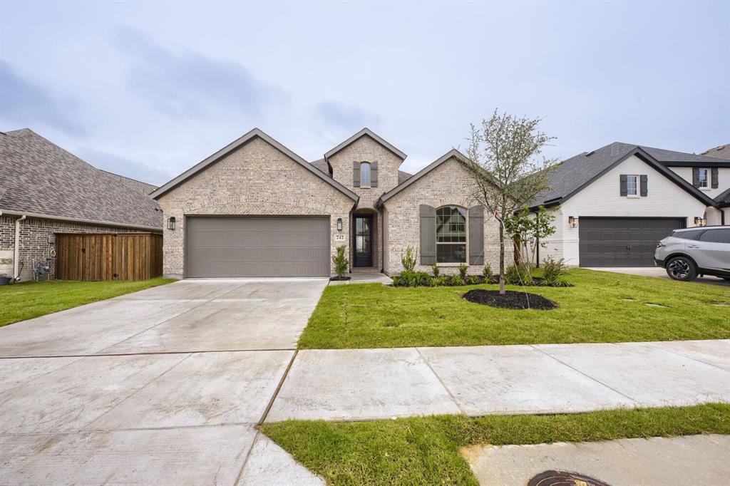 242 Buffalo Boulevard Rhome, TX 76078 - Photo 1 of 28 a front view of a house with a yard and garage
