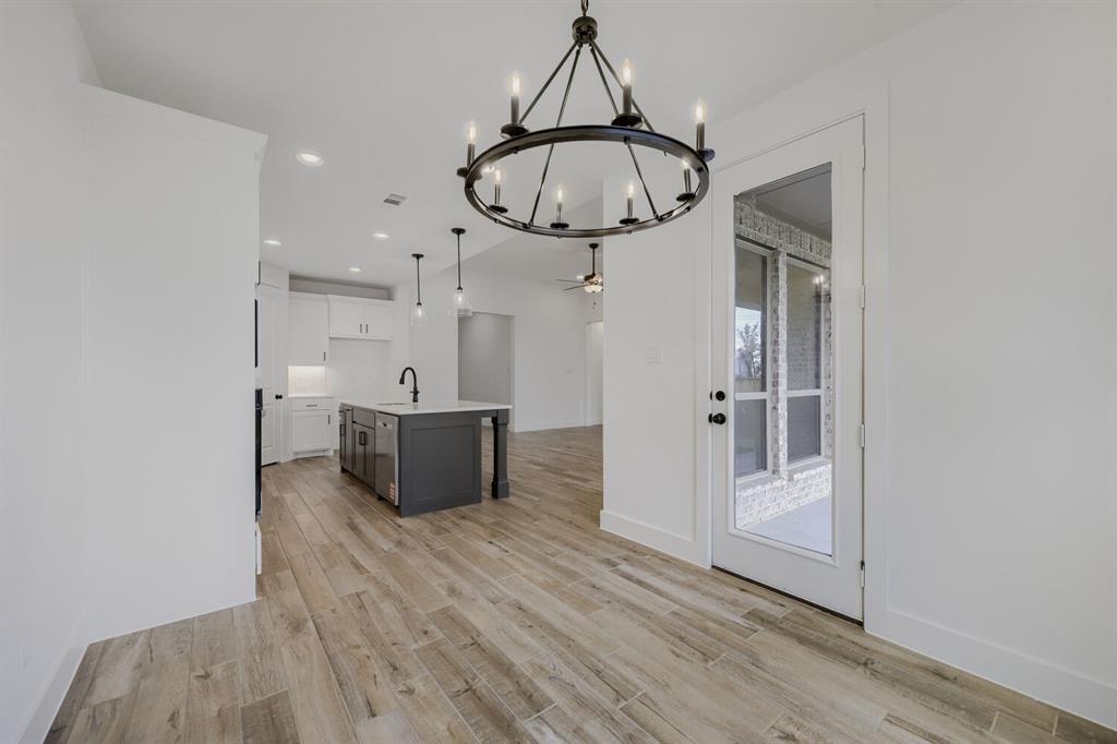 242 Buffalo Boulevard Rhome, TX 76078 - Photo 11 of 28 a view of a hallway with wooden floor and entryway