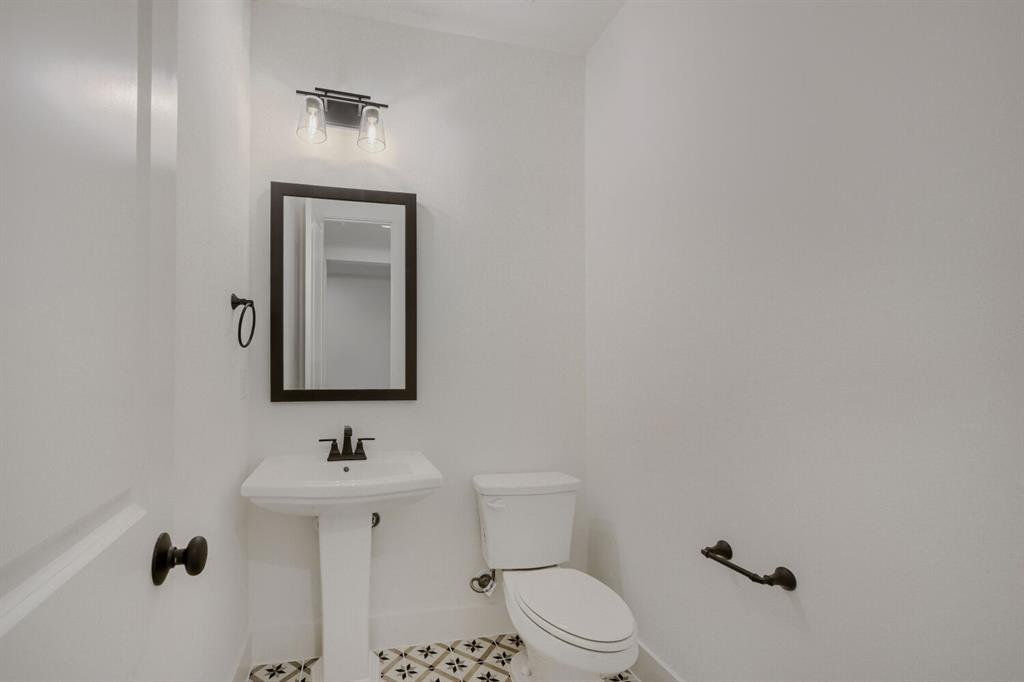 242 Buffalo Boulevard Rhome, TX 76078 - Photo 12 of 28 a bathroom with a toilet sink and mirror