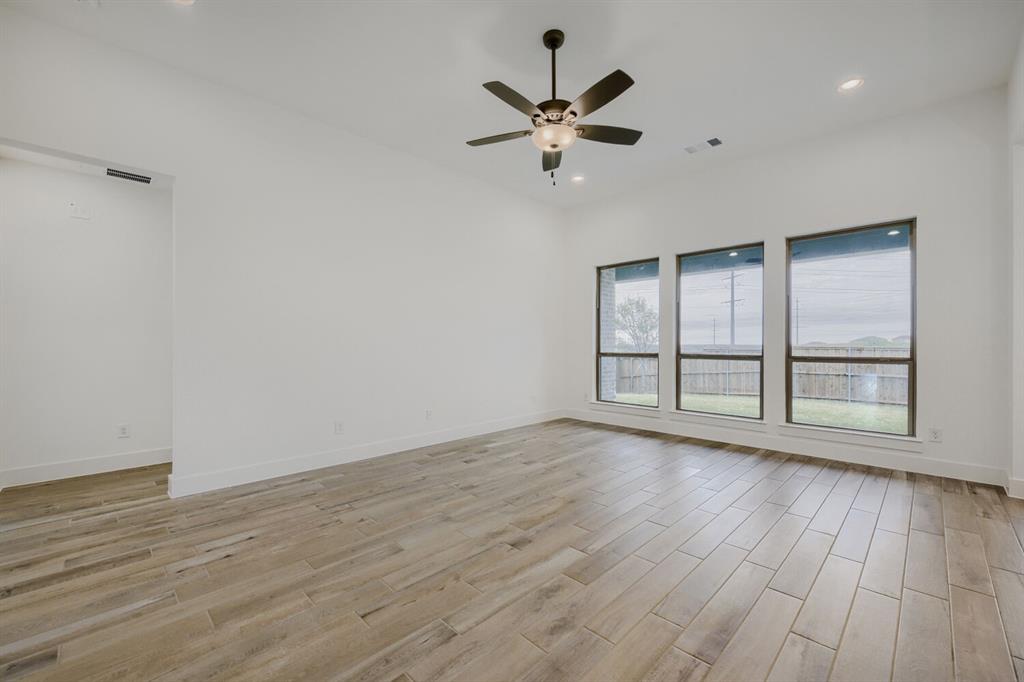 242 Buffalo Boulevard Rhome, TX 76078 - Photo 15 of 28 wooden floor in an empty room with a window