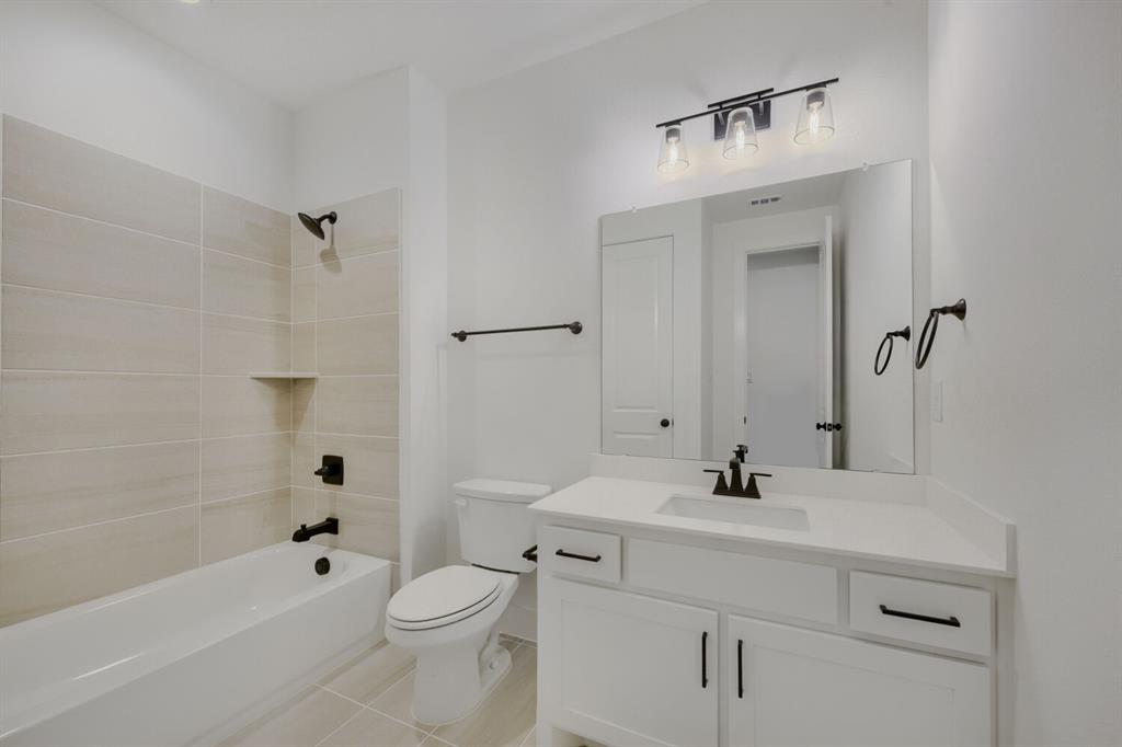 242 Buffalo Boulevard Rhome, TX 76078 - Photo 22 of 28 a bathroom with a sink a toilet and shower