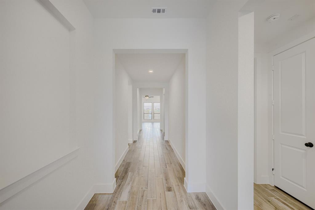 242 Buffalo Boulevard Rhome, TX 76078 - Photo 3 of 28 a view of a hallway with wooden floor