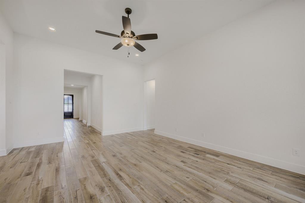 242 Buffalo Boulevard Rhome, TX 76078 - Photo 6 of 28 a view of a room with wooden floor and white walls
