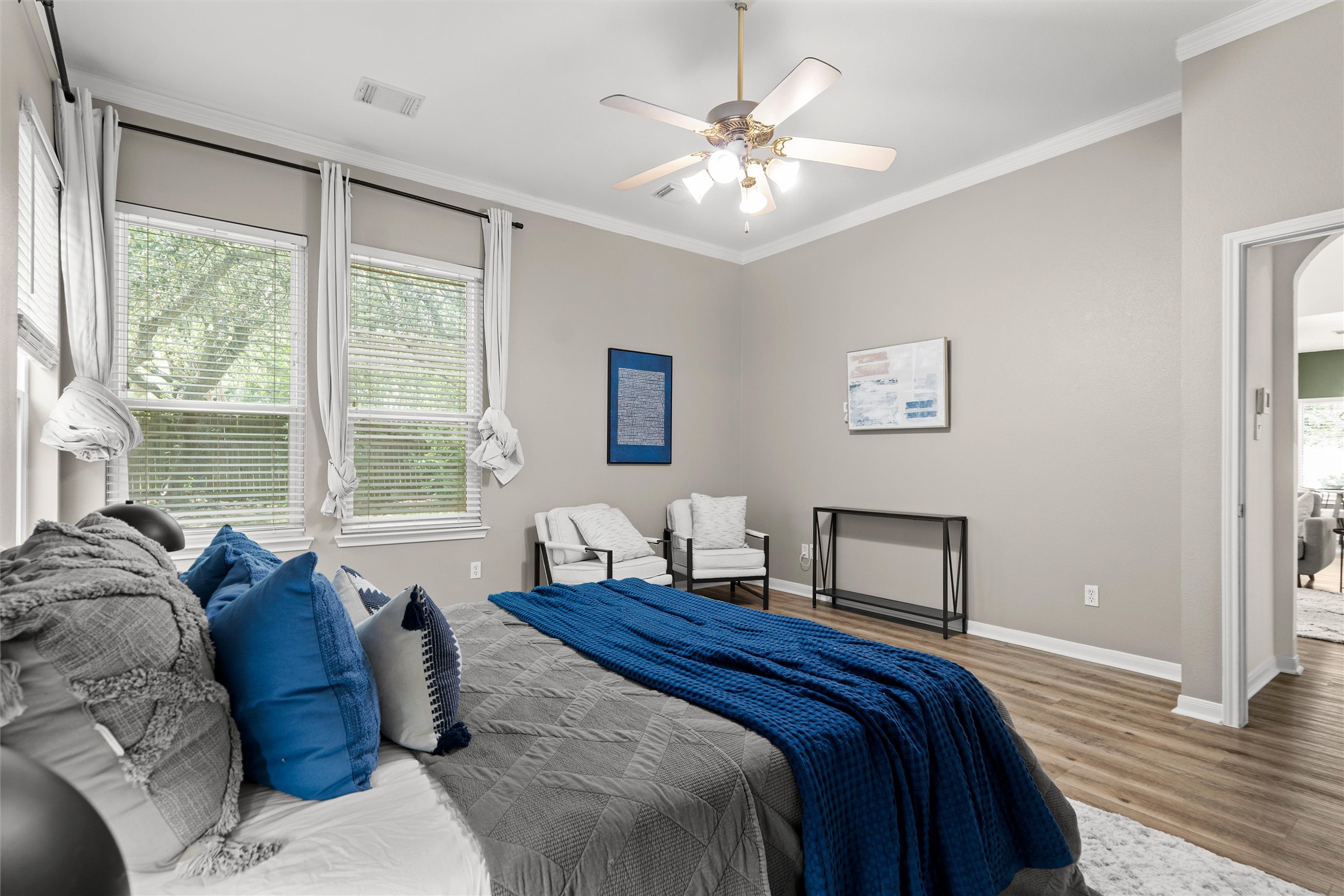 7000 Colberg Court Austin, TX 78749 - Photo 19 of 40 Relax in a bedroom with natural light and elegant crown molding accents.