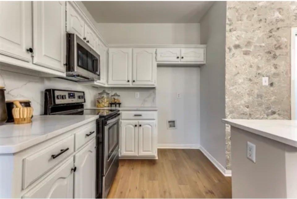 1377 Riley Drive Carrollton, TX 75007 - Photo 14 of 27 a kitchen with stainless steel appliances granite countertop a sink a stove a microwave and cabinets