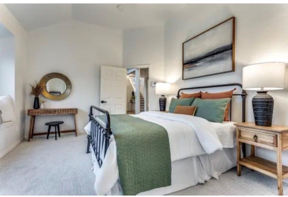 1377 Riley Drive Carrollton, TX 75007 - Photo 19 of 27 a bedroom with a bed a mirror and lamp on desk