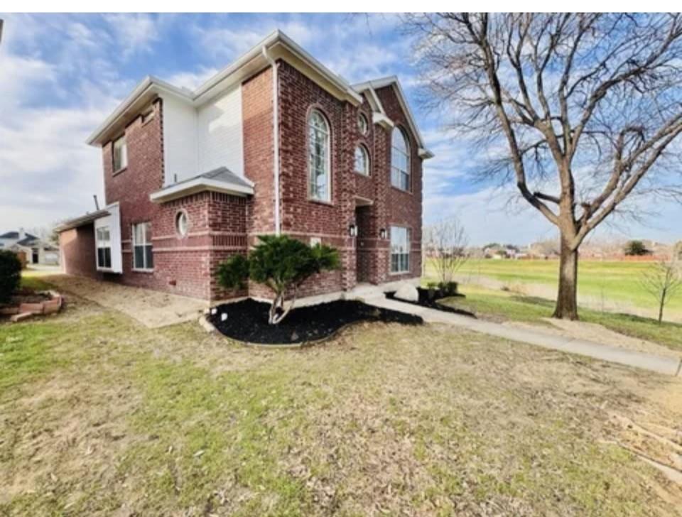 1377 Riley Drive Carrollton, TX 75007 - Photo 3 of 27 a view of a house with a yard and large trees