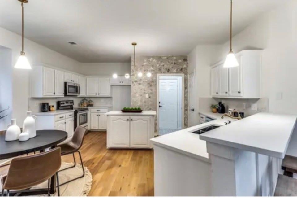 1377 Riley Drive Carrollton, TX 75007 - Photo 10 of 27 a kitchen with a sink stainless steel appliances and white cabinets