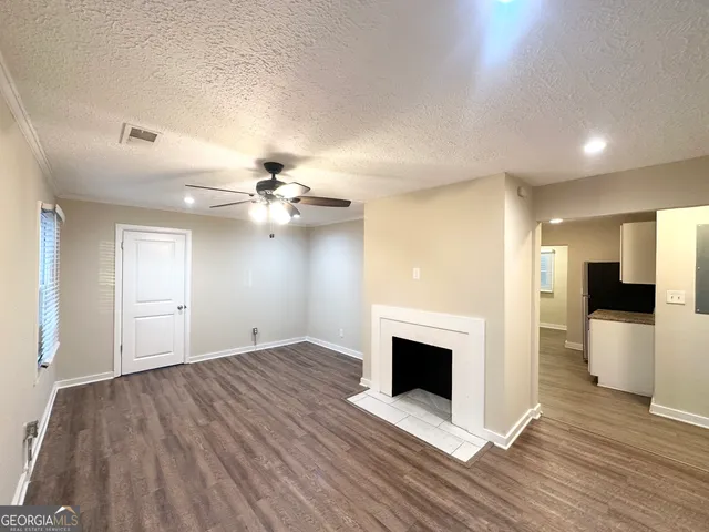 wooden floor in an empty room with a fireplace