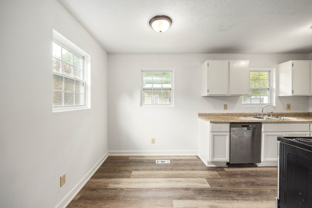 246 Sunnyside Church Road Pine Mountain, GA 31822 - Photo 6 of 26 a view of a kitchen with wooden floor and electronic appliances